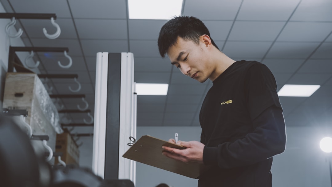 HVAC technician reviewing paperwork near a service van