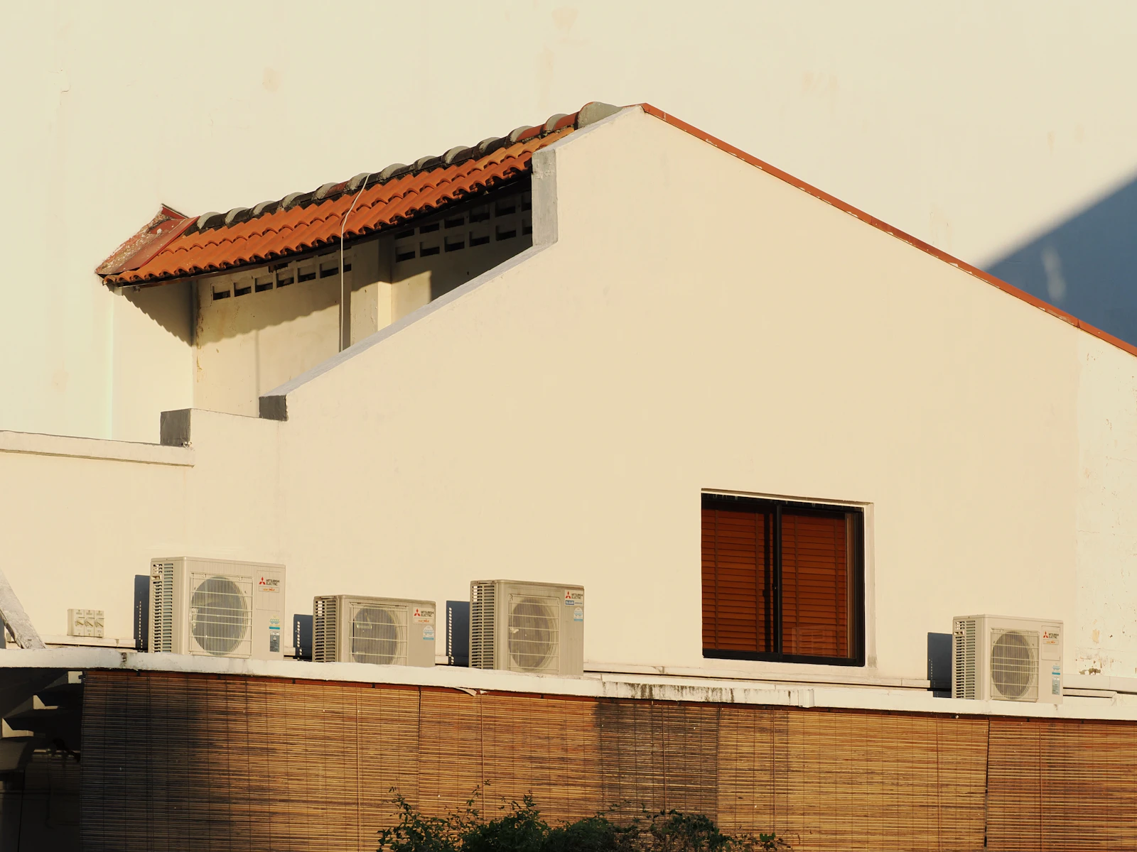 Modern building with HVAC heat pump units on rooftop — the energy code compliance reality