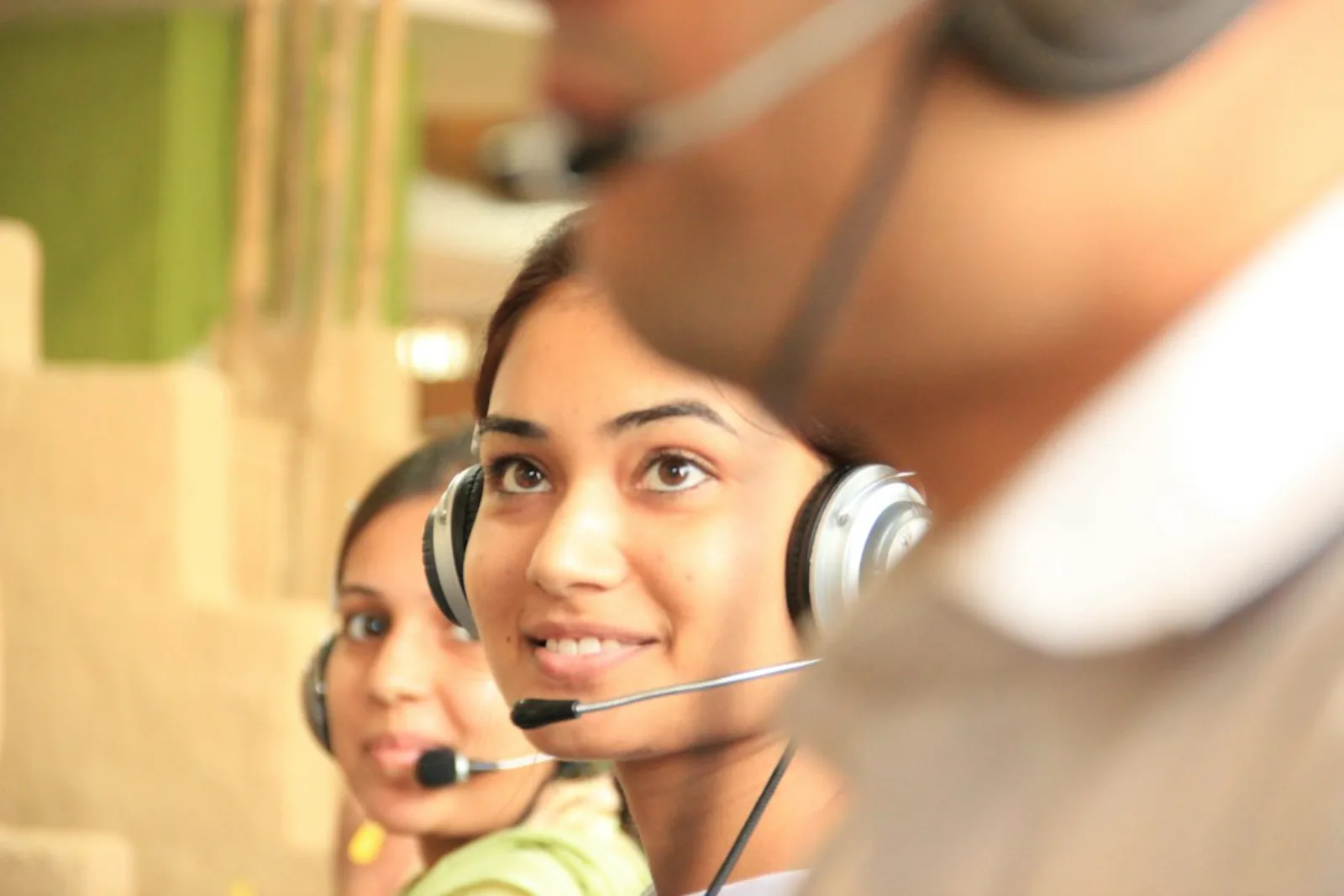 HVAC office receptionist answering phone with headset for customer service call booking