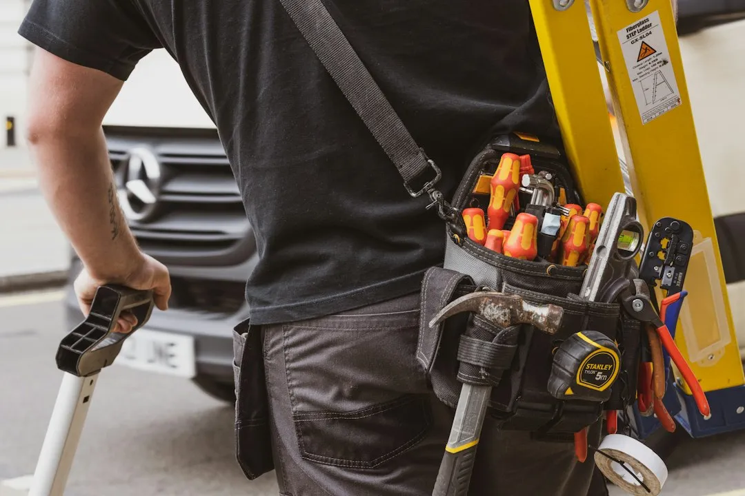 HVAC technician loading tools into service van for a morning service call