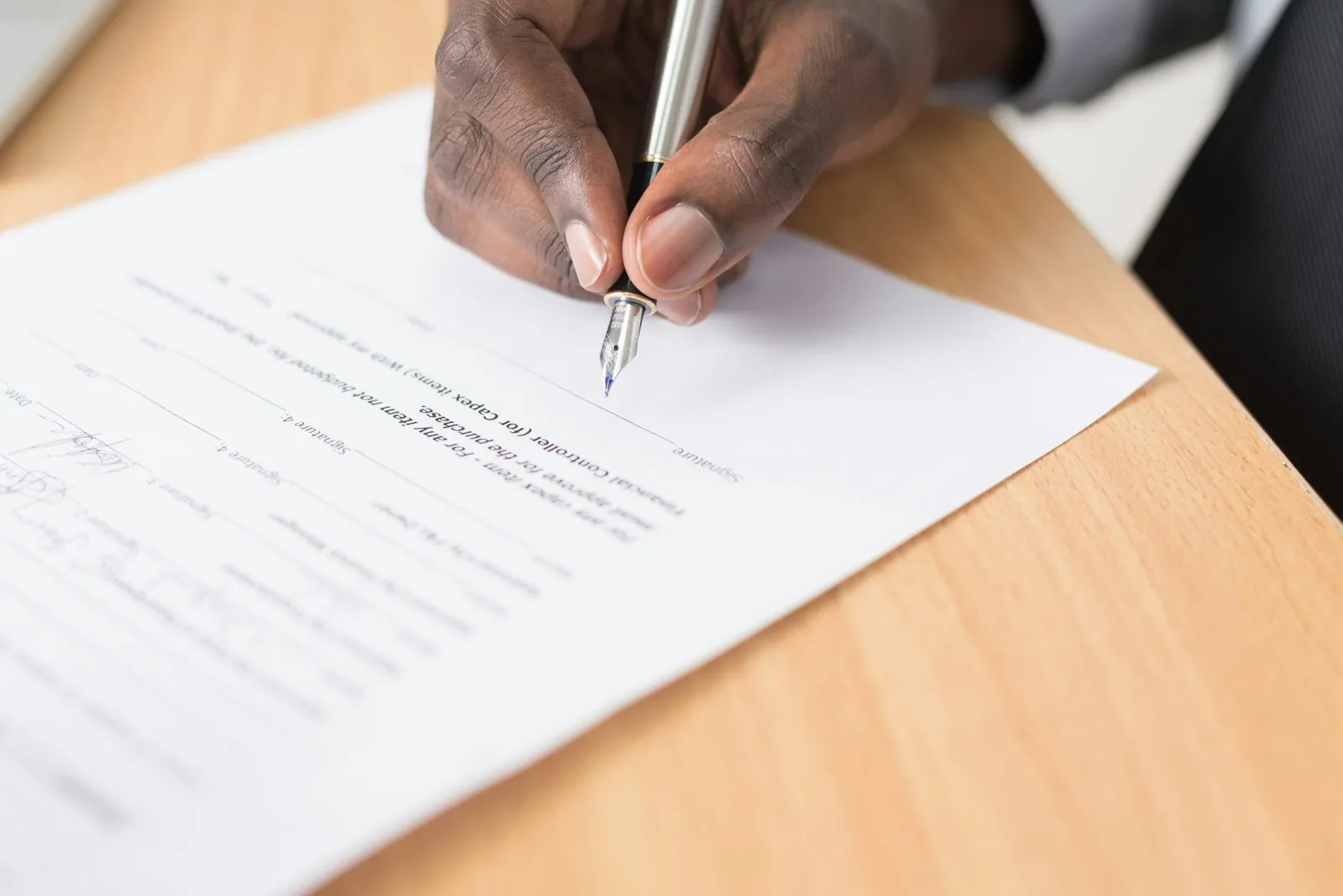 Person reviewing a legal contract document with pen