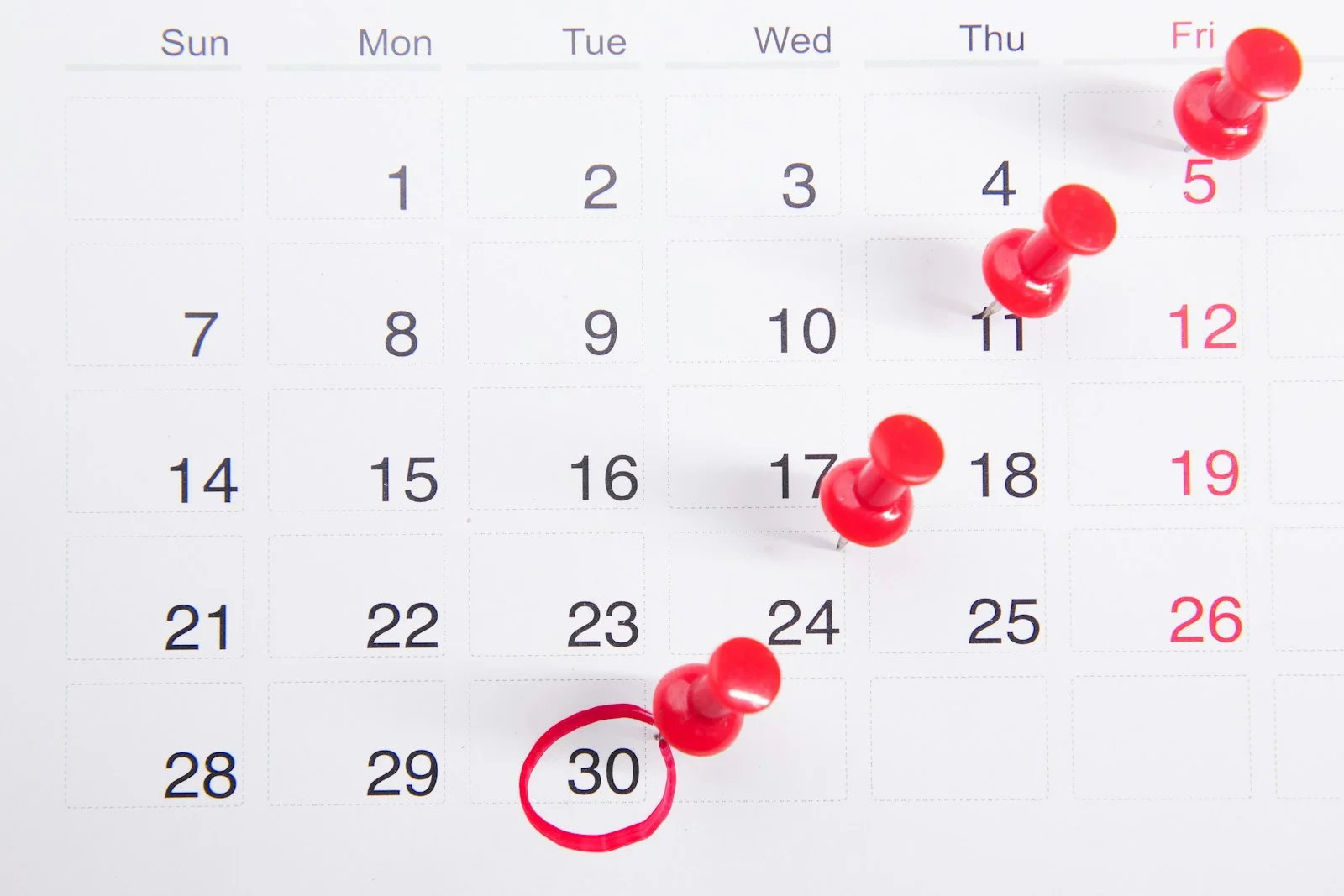 Calendar and business documents on desk for SBA loan closing timeline planning