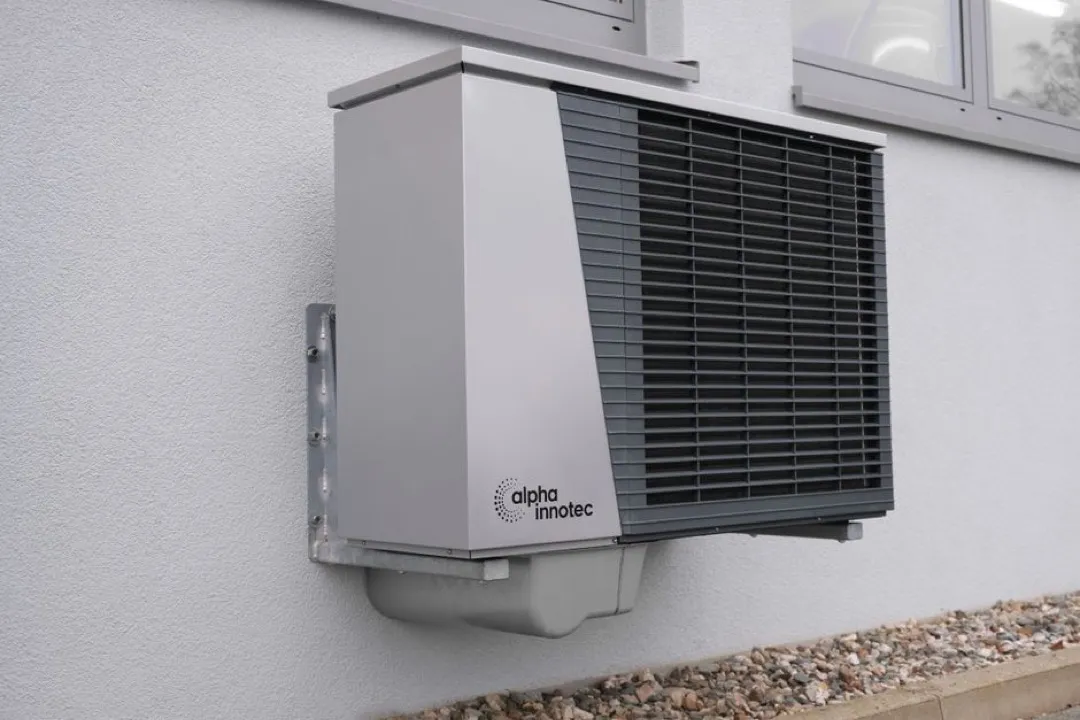 Heat pump outdoor unit at a residential home &mdash; the equipment segment affected by the Section 25C tax credit expiration