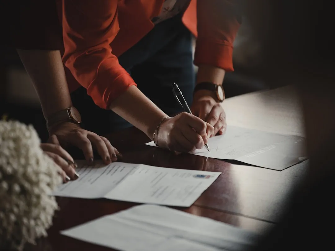 Person reviewing legal documents and official paperwork for a business transaction