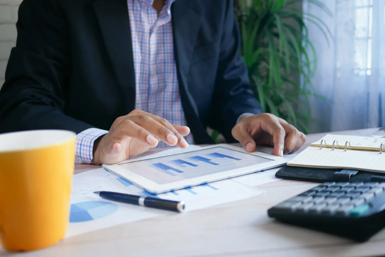 Business owner reviewing financial documents and calculator at desk