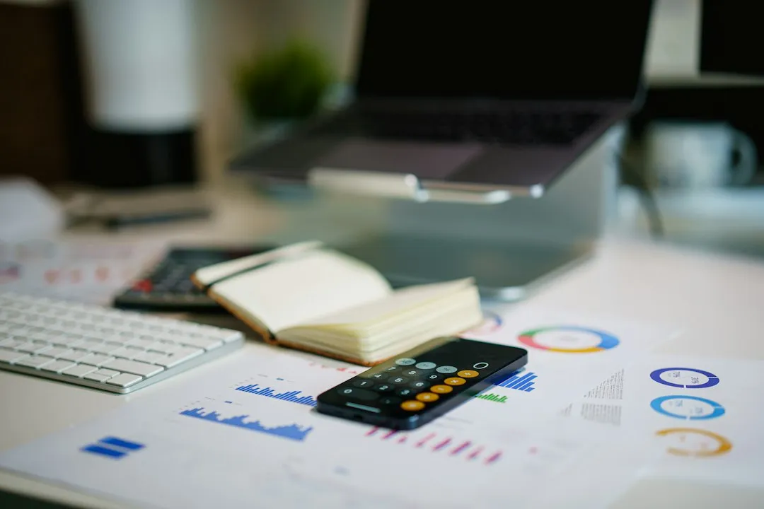 Financial documents and charts spread on a desk for year-end tax planning