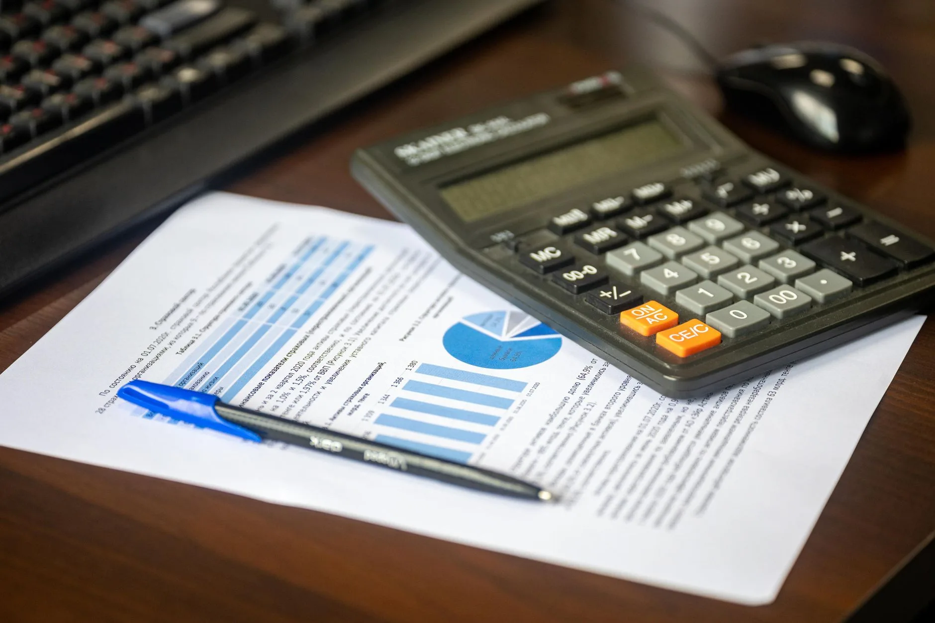Financial documents and calculator showing seller financing deal comparison
